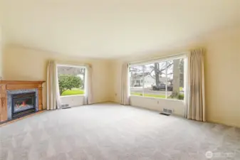 The large picture windows allow a lot of light. The gas fireplace is warm and inviting.