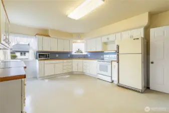 This kitchen has a lot of room and storage...the owners always had a kitchen table in the middle, but maybe an island is more to your liking...