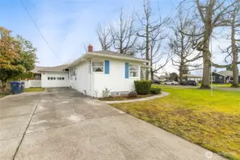 The driveway easily has room for 3 cars to park outside of the garage! You can see the back door off the kitchen to the right...