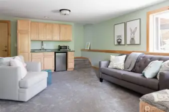 Downstairs family/entertainment room with TV and wet bar with a mini fridge and microwave. Hot tub is right outside this room.
