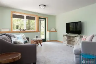 Downstairs family/entertainment room with TV and wet bar with a mini fridge and microwave. Hot tub is right outside this room.