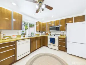 The sink has a view of the back yard.