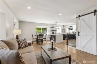 All the details you dream about found in one place! New paint throughout -- modern lighting, kitchen hood fan, hanging pot rack, floating shelves, barn door, iron railing - WOW!