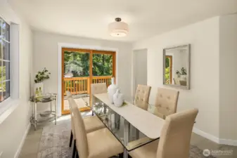 Dining room has a walkout deck overlooking large backyard.