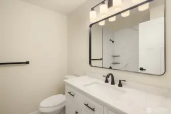 Remodeled upstairs bath with new cabinets, counters and shower/bath.