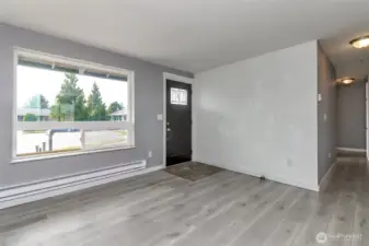 Living room w/large front window for lots of natural light.