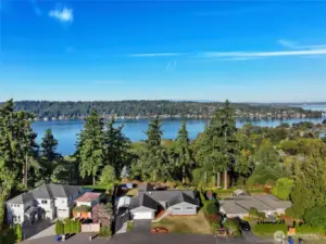 Aerial view of home with lake and city skyline views