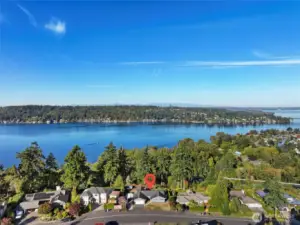 Aerial view of home with lake and city skyline views