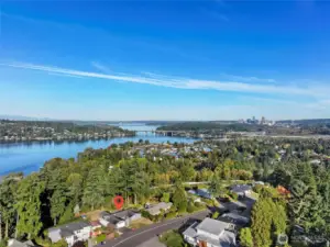 Aerial view of home with lake and city skyline views