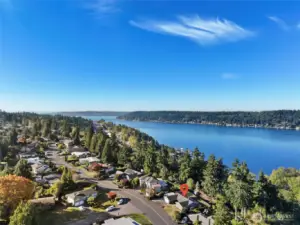 Aerial view of home with lake and city skyline views