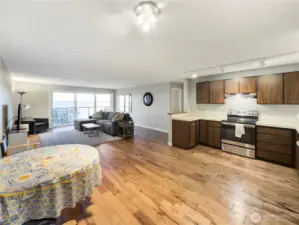 Open concept kitchend flows into the living area with upgraded flooring.