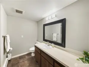 Restroom with nice lights and large mirror.