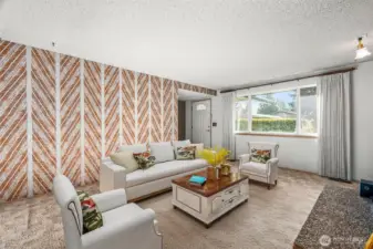 Living room with wood burning fireplace. (staged)