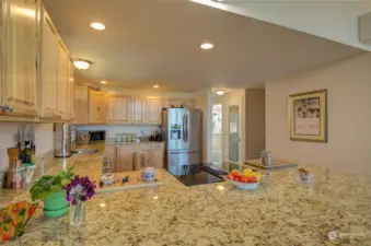 This kitchen has granite countertops and gorgeous cabinets.  Loads of workspace and storage!