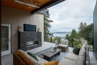 Top floor outdoor living space with gas fireplace, TV hook up, overhead heaters and gas BBQ hook up