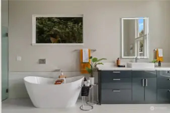 Elegant primary bath with stand-alone soaking tub, and rain-head shower