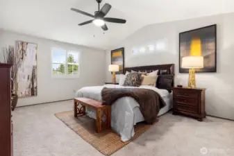 Primary bedroom w/ vaulted ceilings, and ensuite bathroom!