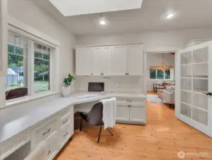 Home office with built-in desk, cabinetry, and backyard views