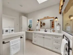 Bathroom with dual vanity, vintage accents, and ample storage