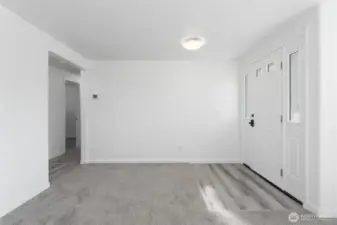 Elegant living space featuring soft new carpet, custom lighting, and a crisp modern palette