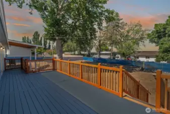 Oversized deck, terraced yard, and flexible layout with two kitchens make this 5BR/3BA home a smart investment or multi-gen haven