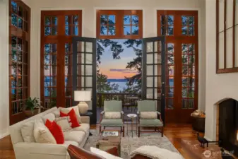 Custom 14 foot wood framed window wall with centered French doors provides abundant natural light and frames sweeping views of the forest and the waters of Port Susan.