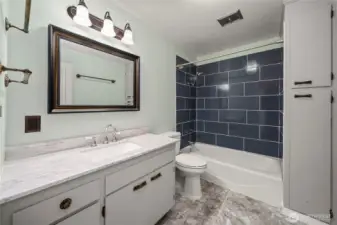 Updated main floor hall bathroom sits between the 2 main floor bedrooms