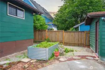 Raised bed in backyard close to kitchen and garage