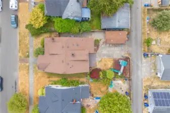 Aerial view of home with view of big toy, the concrete patio provides space for boats, RVs or extra vehicles to be pulled in from the alley