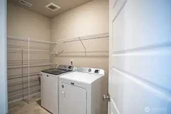 Laundry with lots of storage.  Washer/Dryer stay