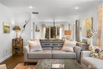 Living room from the fireplace.  The dining room is at the far end.  With Patio and Deck access on the right through sliders.  The kitchen is on the left through that door.