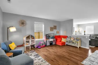 Living room, tons of windows and half wall separating.