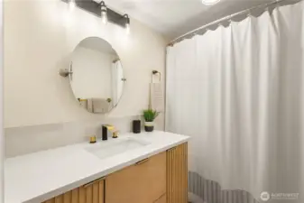 Recently remodeled, this lower level full bath complements the 4th bedroom and guests. The new vanity and fixtures are modern and sleek.