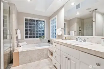 Ensuite primary suite bathroom offers 3/4 shower and soaking tub.