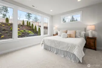 Spacious primary bedroom retreat filled with natural light, offering a peaceful escape within this upgraded newer construction home in McCormick Trails, Port Orchard, designed for comfortable single-level living.