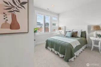 Secondary bedroom privately positioned at the front of the home, featuring plantation shutters and a quiet setting away from the main living area — ideal for guests, office space, or flexible single-level living in this upgraded McCormick Trails home.