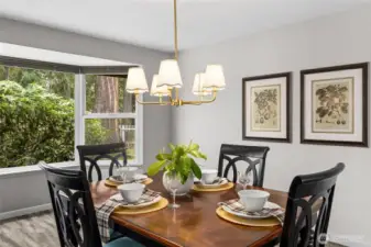 Formal dining room with bay window view to backyard
