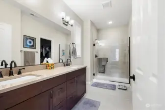 Primary bedroom bathroom with double sinks and walk in shower.