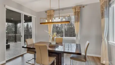 Dining space is just steps from the kitchen with views of the stunning tree lined landscape.