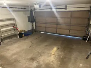 Double garage includes shelving.