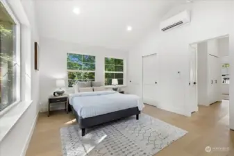 Oversized and spacious primary bedroom.  Vaulted ceilings and windows on 3 sides fill this space with natural light.  Plenty of space for additional seating.