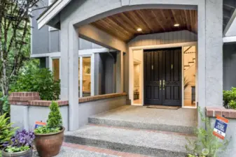As you approach the cedar lined covered front entry double doors open into the voluminous foyer.