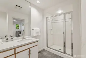 3/4 bathroom with a quartz vanity conveniently located for those who like to work in the yard, kids rolling in the mud or soiled dogs that need hosing off.