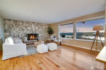 The living room and dining room flow together flanked with these large, picture windows for your incredible backdrop.