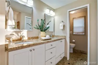 Refreshed primary drive back with dual vanities and shower.