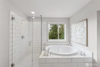 Soaking tub and glass shower with beautiful private view