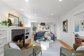 521: Main level, Light filled living room with fire place, plumbed for gas
