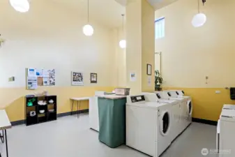 Bright, well-maintained common laundry with modern machines and generous folding space.