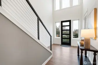 A welcoming entry with soaring ceilings and abundant windows that fill the space with natural light.