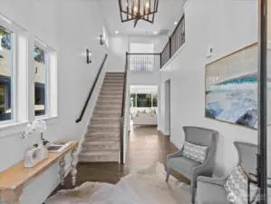 Grand two story entry foyer with pendant chandelier